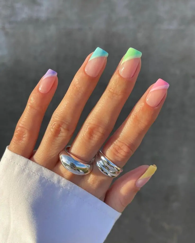 A pastel gradient is a blend of light, soothing colors that smoothly transition from one to another. An easy-to-wear pastel color blend combines hues of pale yellow, soft pink, light purple, and sky blue. You get a silky whisper on your nails.