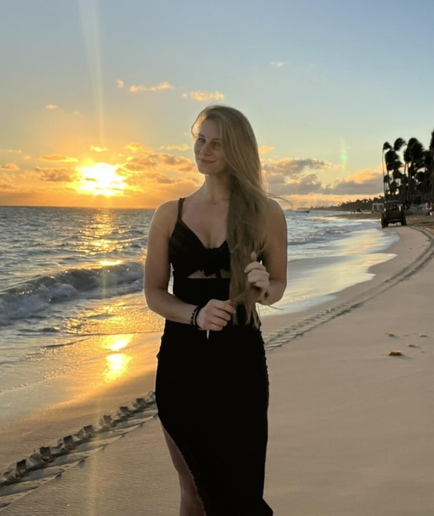 Elegant woman wearing a black Bodycon Maxi Dress with cutout and knot detail at the bust.