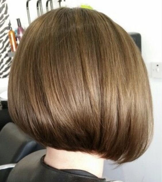 Graduated bob haircut with layers that are shorter in the back for a rounded shape.