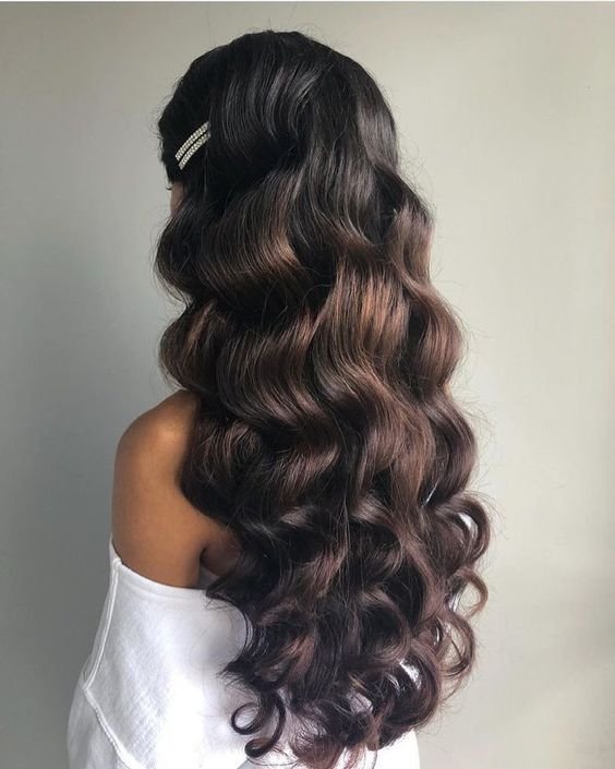 Full bouncy curls, long hair, glamorous look, voluminous hairstyle, special event hair.