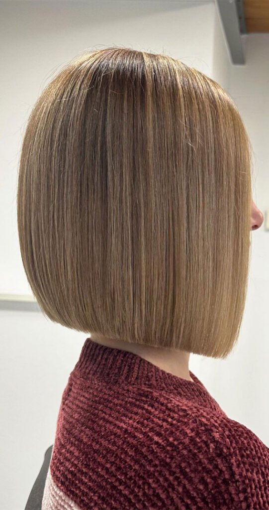 Graduated bob haircut with layers that are shorter in the back for a rounded shape.