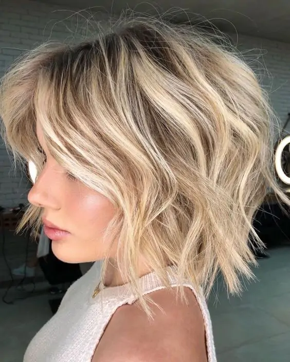Shaggy bob haircut with choppy ends for a textured and carefree look.