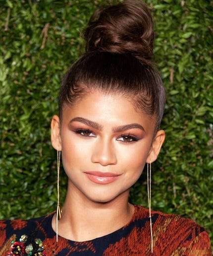 Zendaya’s Effortless Top Knot hairstyle. Effortless and chic, high placement for a modern look. Great for busy days.