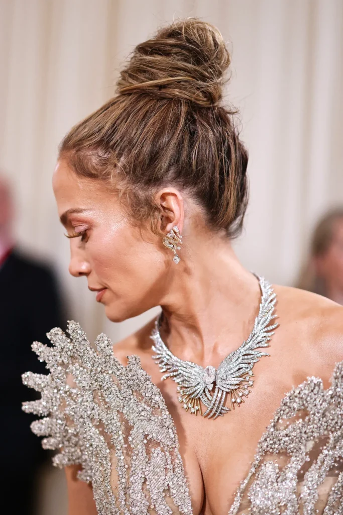 Jennifer Lopez at the Met Gala 2024 Wearing a Crystal Embellished Gown with an Intricate Diamond Necklace and Earrings