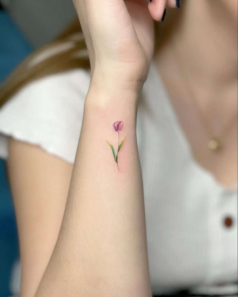 A delicate flower tattoo symbolizes beauty, growth, and nature. Whether it's a single bloom or a small bouquet, this design adds a touch of elegance to your skin. minimalist flower tattoo, simple floral tattoo designs, tiny flower tattoos