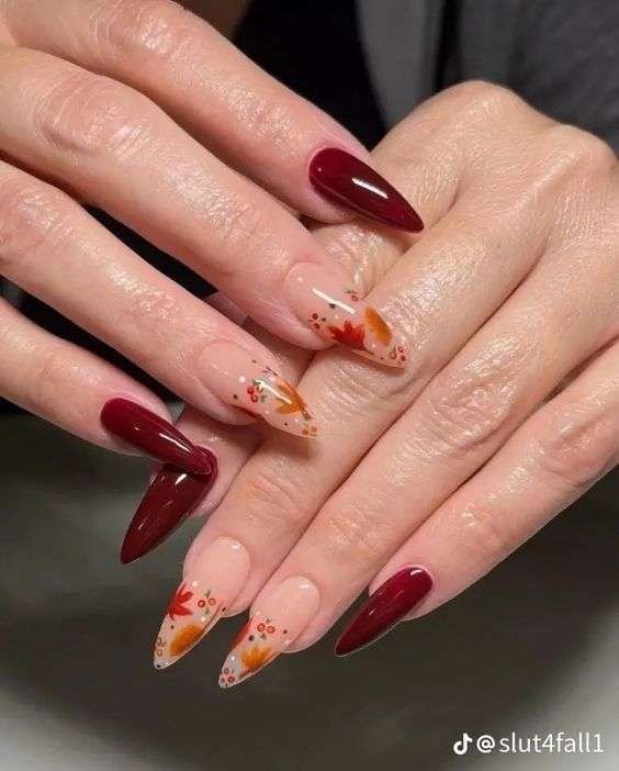 Fall leaf nail art with burgundy polish and transparent nails.