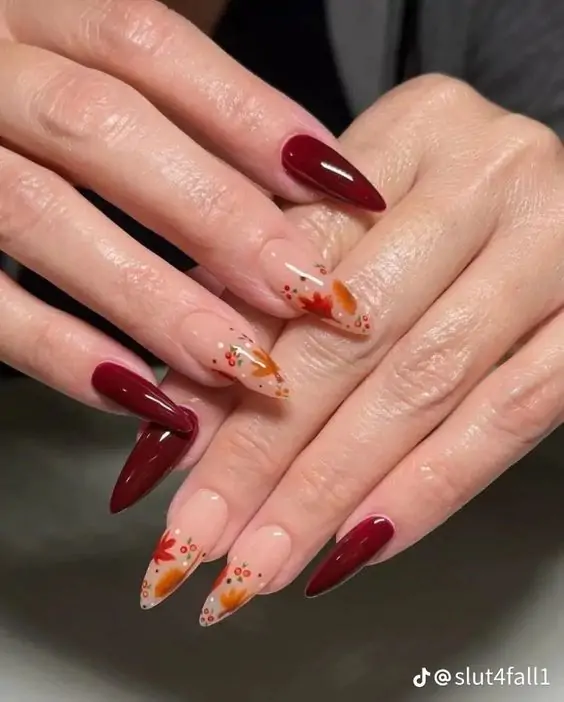 Fall leaf nail art with burgundy polish and transparent nails.
