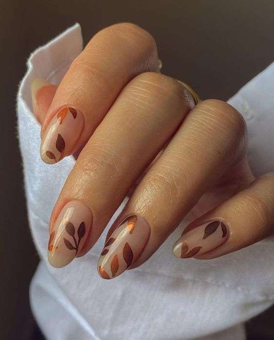 Nude nails with brown and copper fall leaves design.