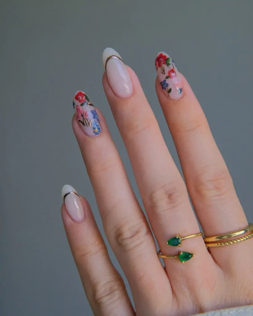 Fall-inspired nail art with floral designs and nude shades.