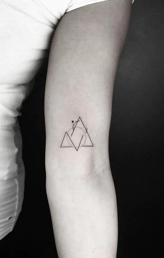 Geometric shapes like triangles, circles, or squares make for striking minimalist tattoos. They are clean, sharp, and can symbolize balance, harmony, and stability.