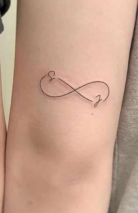 The infinity symbol is a simple yet powerful design representing eternity, endless love, or boundless possibilities. It's a popular choice for minimalist tattoos. minimalist infinity tattoo, small infinity tattoo ideas, simple infinity tattoos