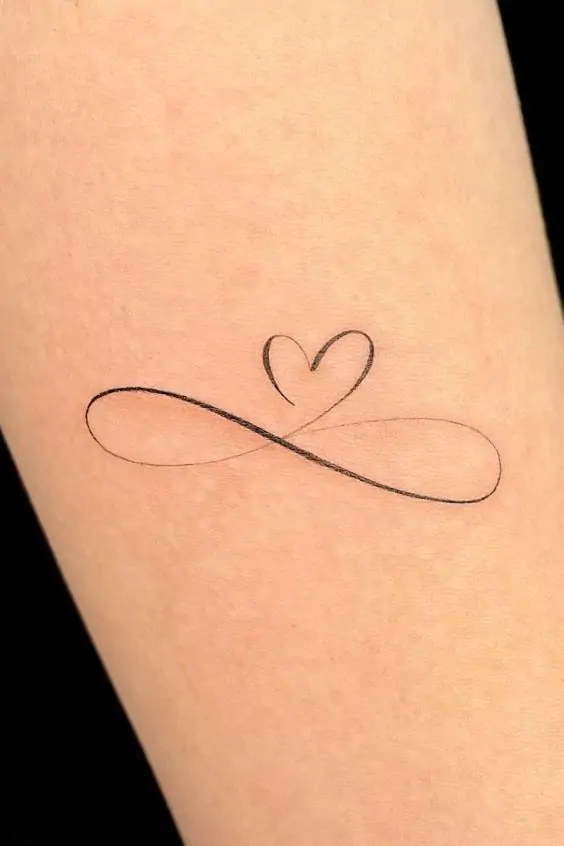 The infinity symbol is a simple yet powerful design representing eternity, endless love, or boundless possibilities. It's a popular choice for minimalist tattoos. minimalist infinity tattoo, small infinity tattoo ideas, simple infinity tattoos