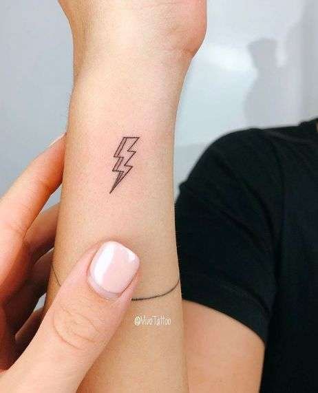 A small lightning bolt tattoo is a striking design that symbolizes power, energy, and inspiration. It's a great choice for those who want a bold yet minimalist look.minimalist lightning tattoo, small bolt tattoo ideas, simple lightning tattoos