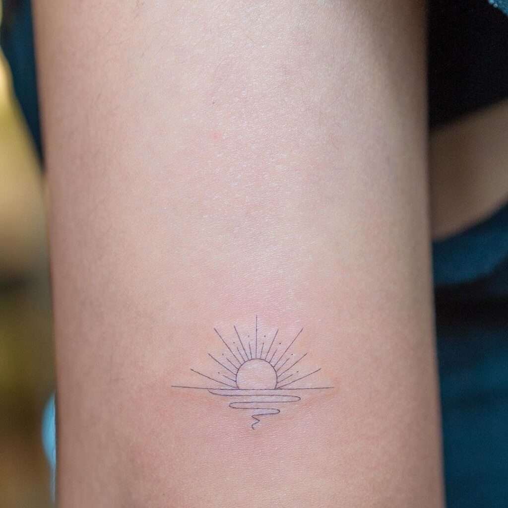 A small sun tattoo can symbolize life, energy, and positivity. It's a great way to bring a little brightness to your life every day.minimalist sun tattoo, small sun tattoo designs, simple sun tattoos