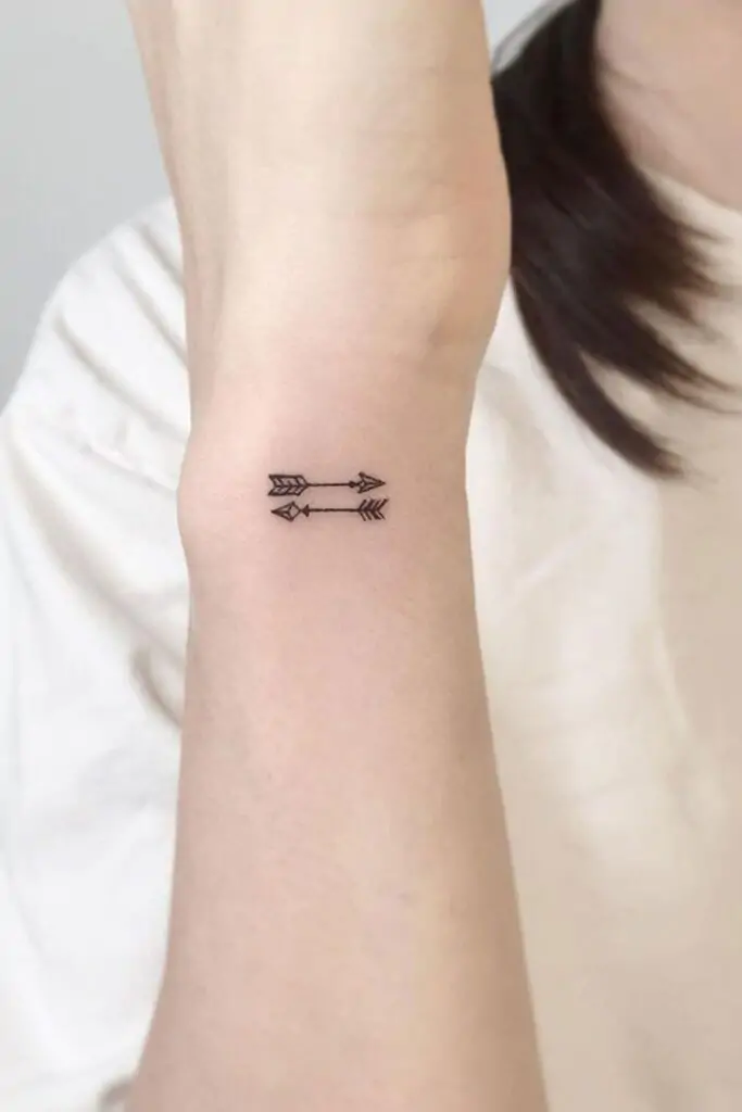 Arrows are popular in minimalist tattoo designs because they symbolize direction, focus, and moving forward. A simple arrow on your forearm or behind your ear can be a constant reminder to stay on your path. minimalist arrow tattoo, small arrow tattoo ideas, simple arrow tattoos
