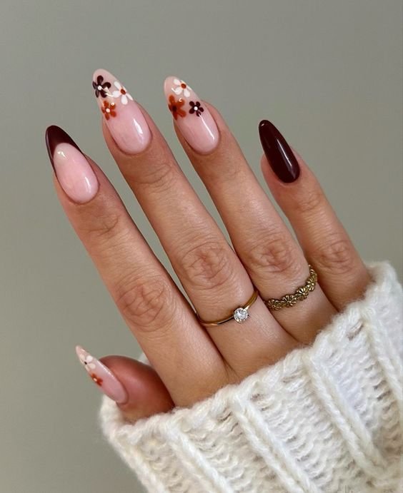 Fall floral nails with dark brown accent nails.