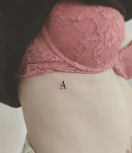A tattoo with your initials, a loved one's initials, or a meaningful word is a subtle way to carry a personal connection. This design can be placed anywhere on the body and can be as small as you like. minimalist lettering tattoo, simple initials tattoo, tiny word tattoos