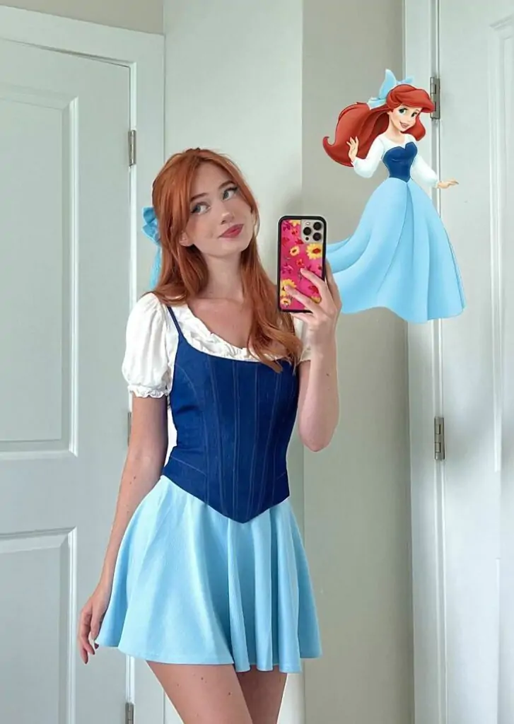 Woman dressed in a blue fairytale princess Halloween costume with a corset top and puff-sleeve blouse.