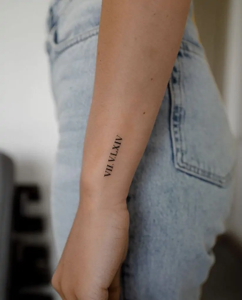 Roman numerals can represent important dates or numbers in your life. A minimalist Roman numeral tattoo is a subtle yet meaningful way to keep those moments close. minimalist Roman numeral tattoo, small date tattoo designs, simple numeral tattoos