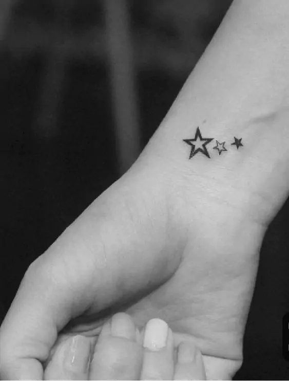 Stars are a timeless tattoo design that represents hope, guidance, and dreams. A single star or a small cluster of stars can look stunning as a minimalist tattoo.