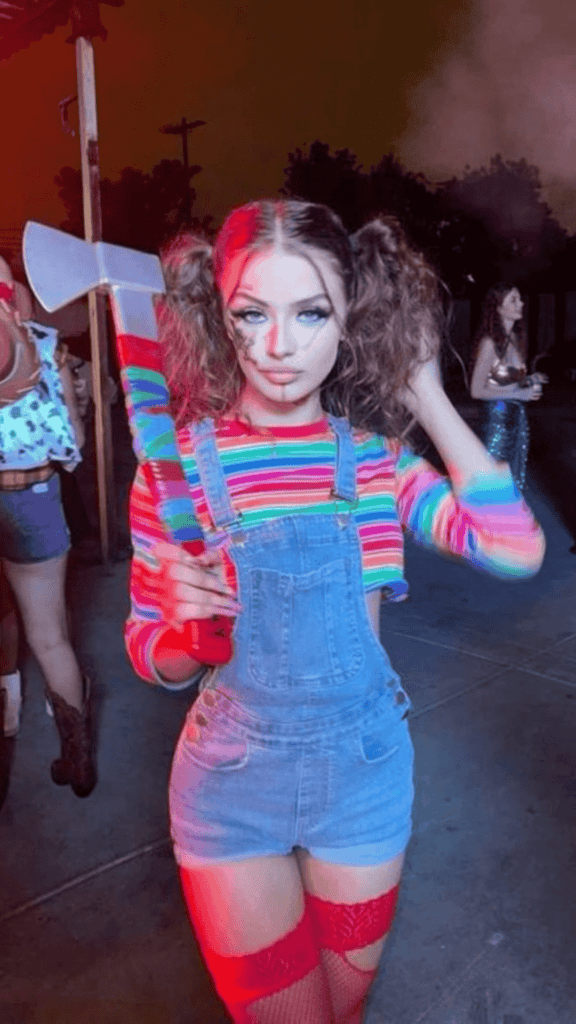 The Halloween look is inspired by chunky feature denim material overall, paired with a rainbow-striped shirt and red thigh-high stockings, with the ensemble completed by a fake axe.