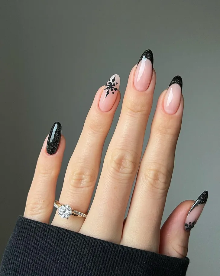 Give your black manicure a festive twist! If black is your go-to shade, this is the ideal way to make it more seasonal. Combine solid black polish with timeless French tips and a stylish snowflake design for winter nails that are both bold and sophisticated.