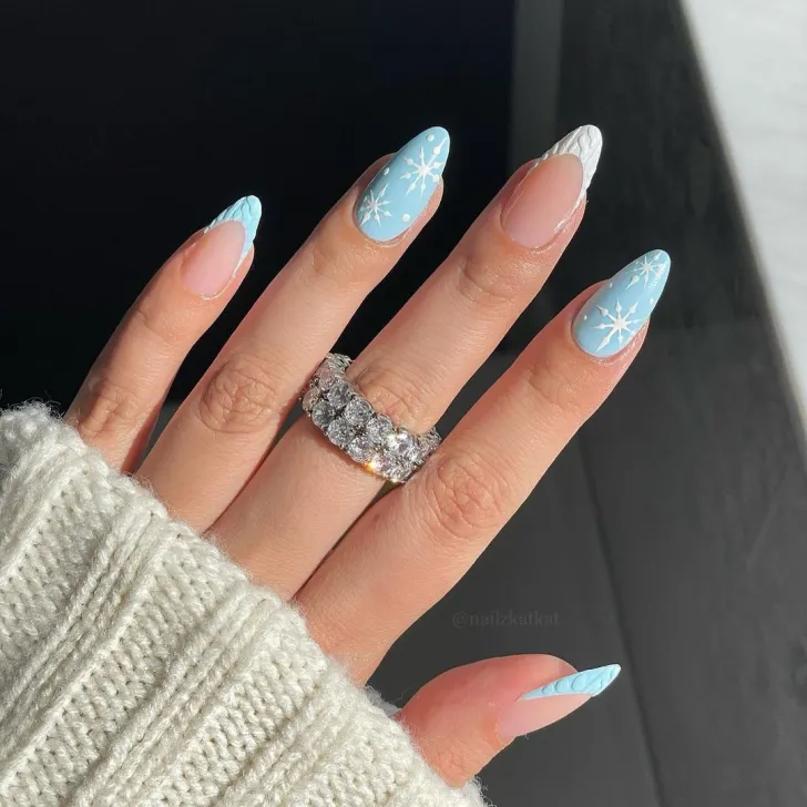 Snowy Blue Manicure With Sweater Inspired French Tips. Our two favorite winter essentials: snow and sweaters. And this nail design has both!