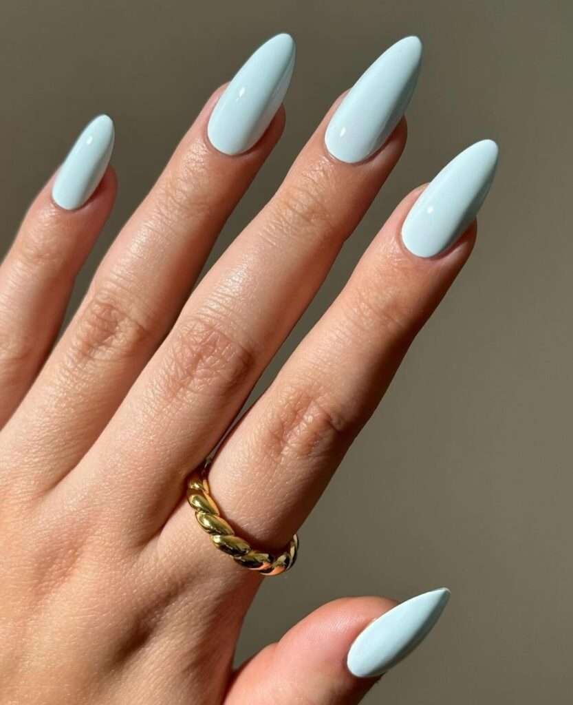 A soft, icy blue polish perfect for winter vibes, elongating your fingers with an elegant almond shape. The serene blue hue complements winter fashion, adding a sophisticated touch. Perfect for adding seasonal charm to your look.