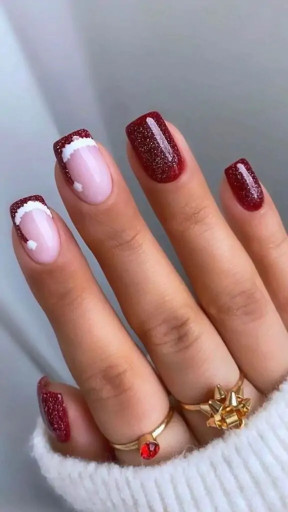 These festive nails feature a classic red glitter base with a French tip accented with white fur, reminiscent of Santa's hat. The playful design adds a touch of whimsy and holiday cheer, making them perfect for Christmas parties and gatherings.