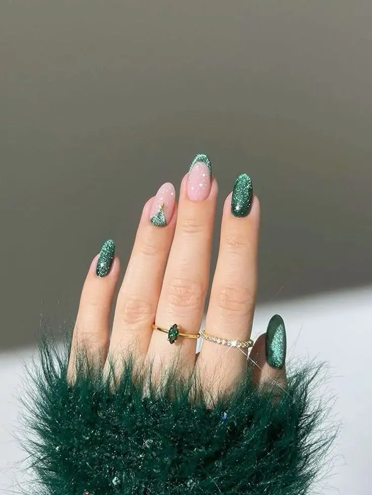 These festive nails feature a deep green glitter base with a delicate Christmas tree design on the accent nail. The combination of classic green and a touch of sparkle creates a sophisticated and glamorous look, perfect for the holiday season.
