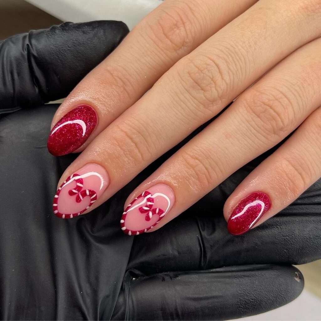 Some nails are coated in a rich, shimmering red glitter, like the glossy wrapper of a holiday sweet. The other nails have a sheer, natural base, allowing the focus to be on the charming designs. Delicate red and white stripes, reminiscent of classic candy canes, form the outline of a heart shape on these nails. Inside the heart, tiny red bows add an extra touch of sweetness and detail. This design is playful, festive, and undeniably adorable, perfect for expressing holiday cheer with a touch of whimsy.