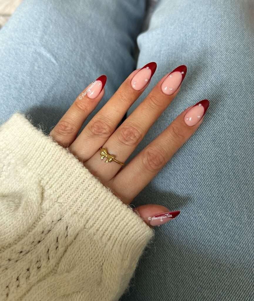 This elegant nail look features a classic French manicure with a deep cherry red tip, adding a touch of festive warmth.
The soft, milky white base creates a delicate contrast, reminiscent of fresh winter snow. This sophisticated design is perfect for adding a touch of holiday glamour to any occasion.