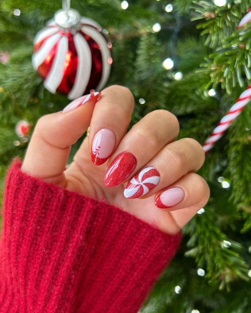 A tiny, stylized candy cane design on one nail adds a final touch of holiday sweetness, making this a playful and festive look. This sweet manicure is inspired by classic Christmas candy canes. A shimmering red polish covers one nail, while others feature a delicate pink base with red tips or whimsical candy cane stripes.