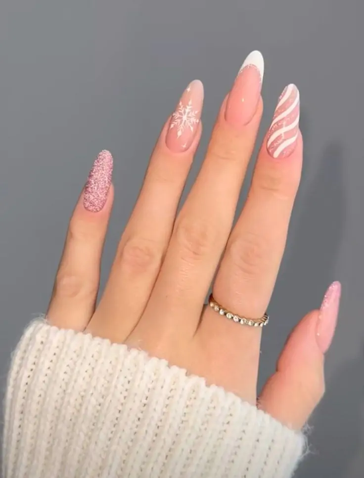 These festive nails feature a soft pink base with a French tip accented with silver glitter and snowflake and candy cane designs. The playful design adds a touch of whimsy and holiday cheer, making them perfect for Christmas parties and gatherings.