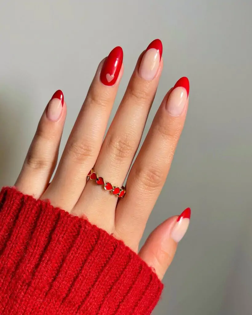 Oh my gosh, I'm obsessed! These nails are so cute. The classic French tip is always chic, but the way the red peeks out from under the white is just adorable. It's like a little Valentine's Day surprise with every movement of your hand. I'm definitely going to show this to my nail tech!