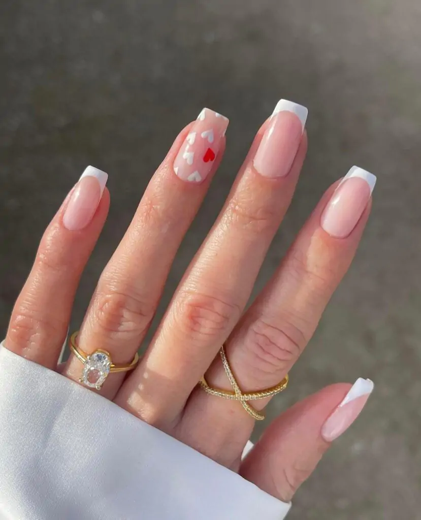 These nails are so sweet! The classic French tip is always chic, and the tiny red hearts scattered across the base are just adorable. It's like a little bit of Valentine's Day magic on your fingertips.