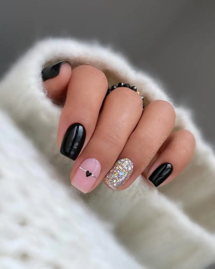 These nails are so edgy and chic! I love the contrast of the matte black with the sparkly pink and that tiny heart detail. It's a perfect mix of tough and sweet. I'd definitely get compliments on these!