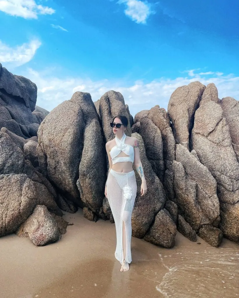 Immerse yourself in Seaside Allure—channeling the perfect blend of elegance and effortless style with a stunning white mesh halter top and a long skirt featuring a chic slit. Perfect for capturing serene beach moments, accessorize with delicate jewelry and strappy sandals to complete this captivating, airy look.