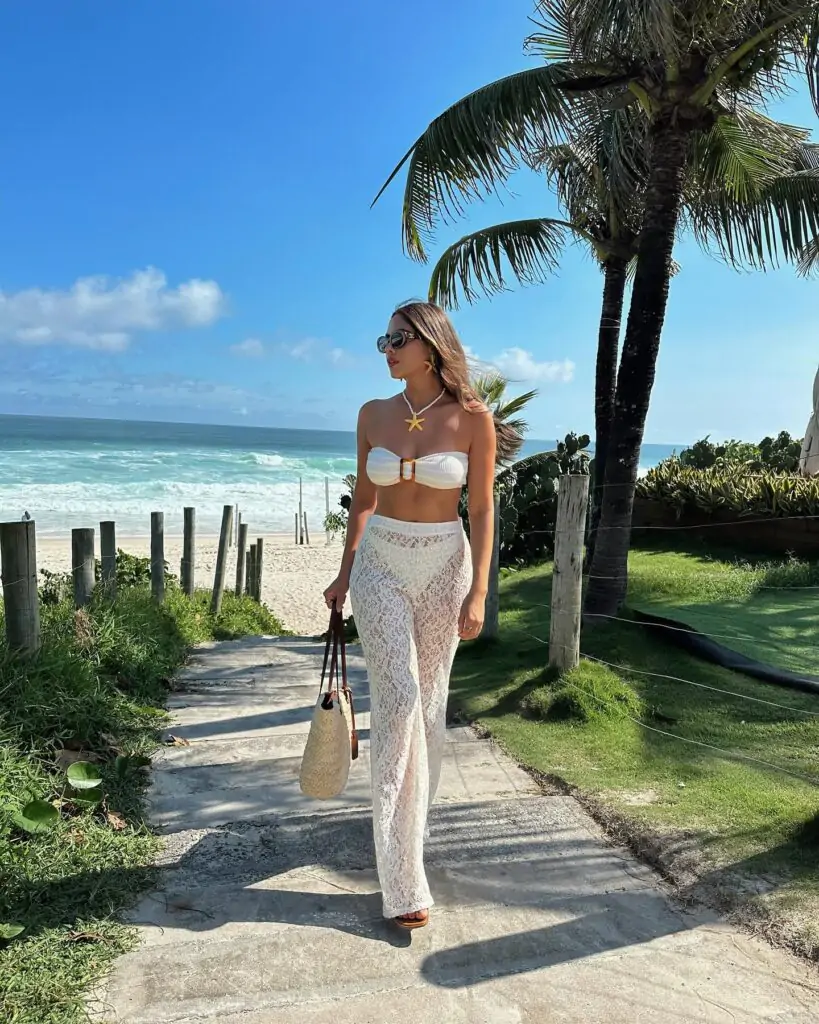 Feel the ocean breeze with Ocean Breeze Chic—a whimsical, sky-blue maxi dress with delicate floral embroidery, paired with an elegant sun hat and matching espadrilles. Perfect for turning heads during your next beachside getaway.