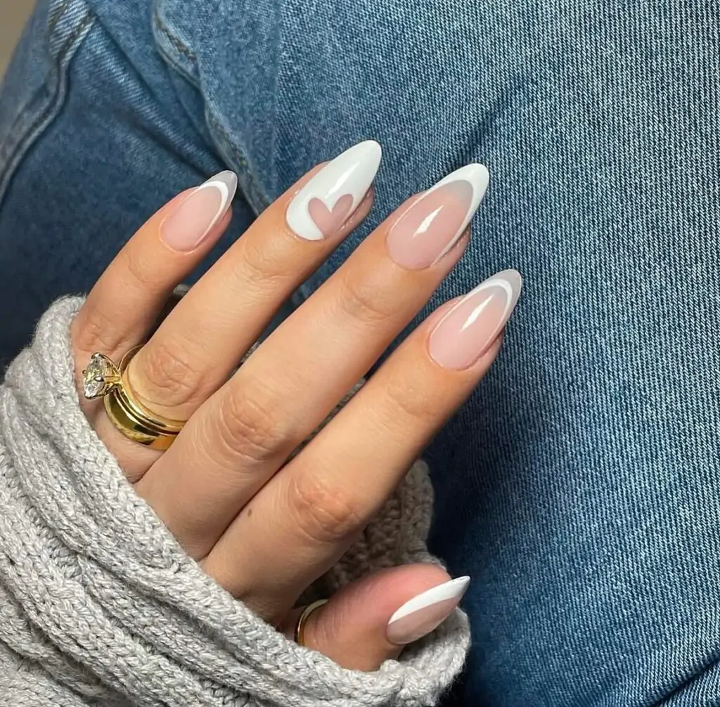 I love this! It's like the classic French manicure got a sweet little upgrade. The white tips are so clean, and that tiny heart peeking out is just adorable. It's elegant, but still has a playful touch. I could totally see myself wearing this for a special date or even just to feel a little extra fancy.