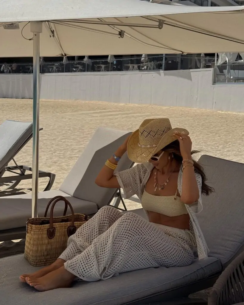 Sandy Chic captures the essence of beach elegance with a sophisticated beige crochet dress and a chic straw hat, perfect for a stylish seaside look.