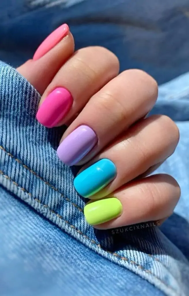 These playful mani's will brighten up your spring days. With these bold, colorful nails in shades of pink, purple, blue, and lime—you’ll feel so lively with this look! These playful nail designs will brighten up your spring days.