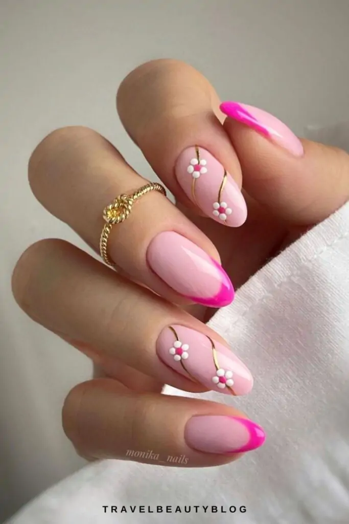 I’m here to keep my audience on trend! You’ll feel so glamorous with this look! We love how the tiny flowers add a touch of whimsy to your mani. I’m swooning over these almond nails with vibrant pink tips and delicate gold lines.
