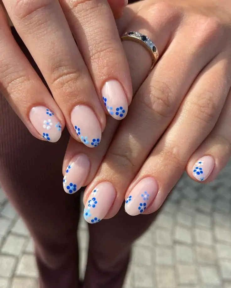 I’m ready to keep the inspiration flowing for you! You’ll adore these soft nude spring nails with tiny blue daisies—I’m feeling all the fresh vibes with this look! This delicate design will be your go-to for a blooming nail moment.