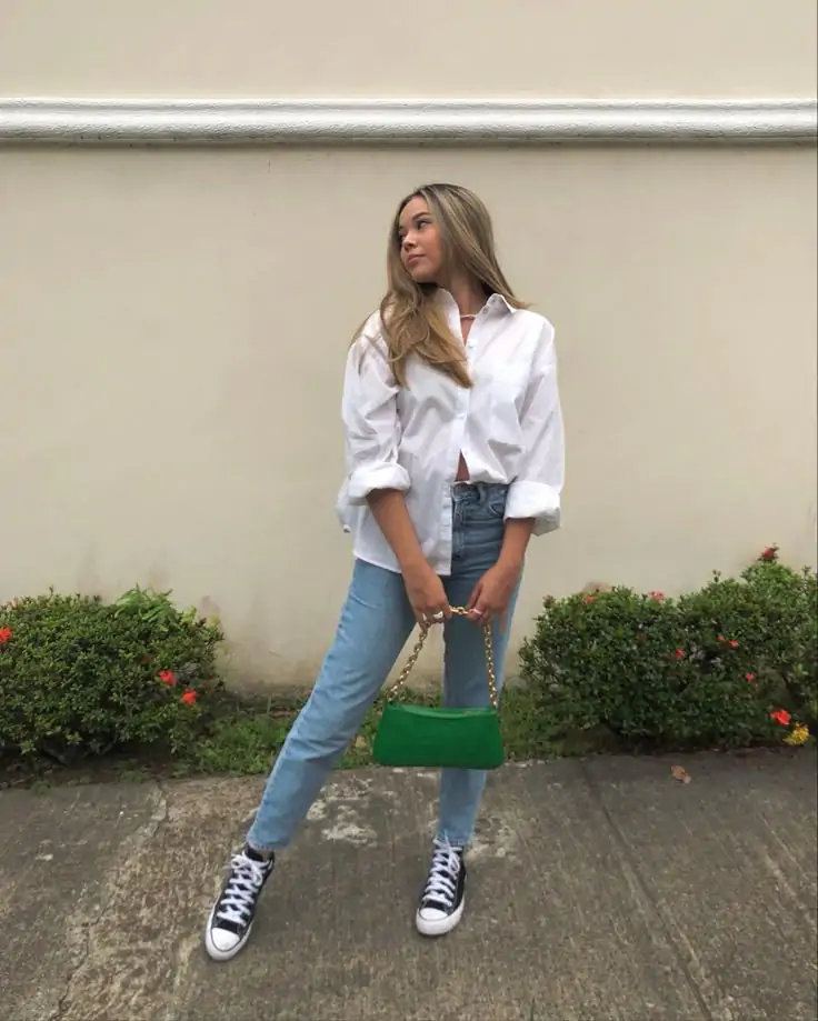 Outfit Idea: A crisp white button-down shirt tucked into high-waisted, wide-leg denim jeans. Pair it with a cute straw hat, chunky sneakers, and oversized sunglasses. Why It Works: Effortless yet elevated; perfect for spring days that require minimal effort but still look polished. The wide-leg jeans are trending and are perfect for both comfort and style.
