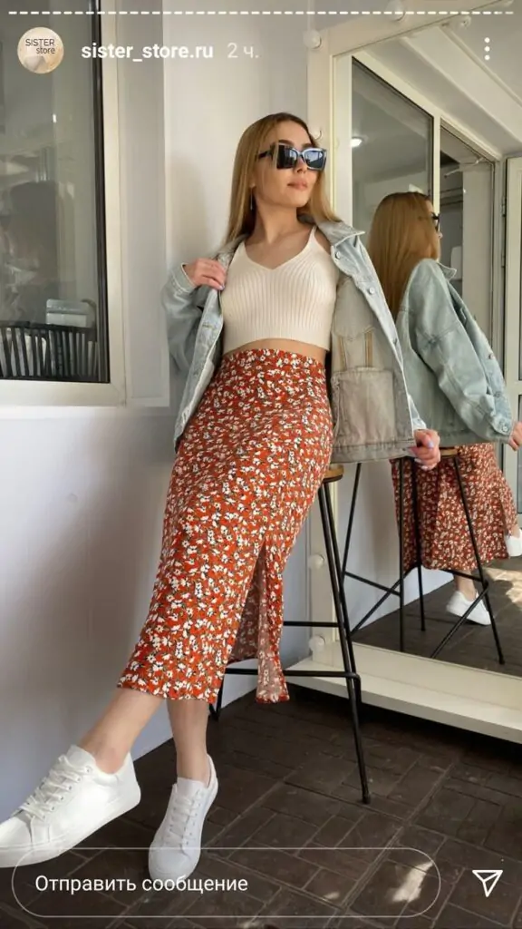 A floral midi skirt paired with a fitted denim jacket and white sandals. Accessorize with a floppy hat and simple jewelry. Why It Works: A mix of relaxed and feminine, this outfit is perfect for everything from a day trip to a casual outdoor gathering. The floral skirt screams spring, while the denim jacket gives it a cool edge.