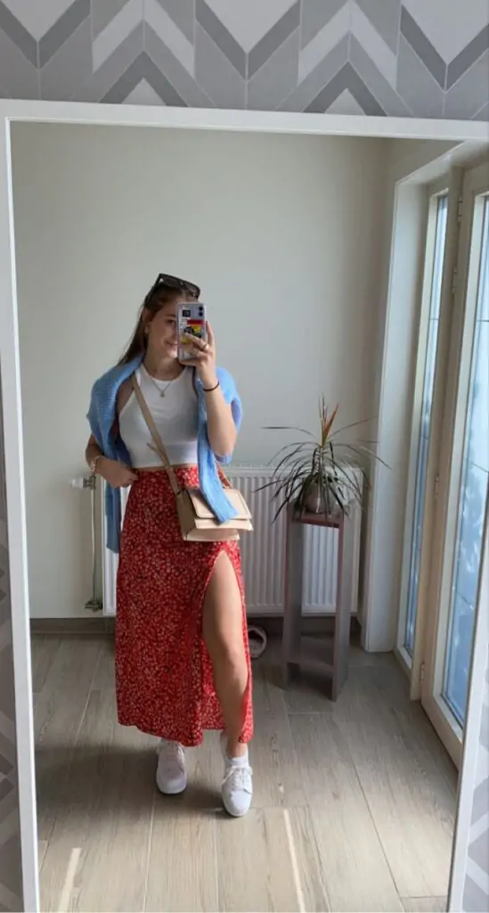A floral midi skirt paired with a fitted denim jacket and white sandals. Accessorize with a floppy hat and simple jewelry. Why It Works: A mix of relaxed and feminine, this outfit is perfect for everything from a day trip to a casual outdoor gathering. The floral skirt screams spring, while the denim jacket gives it a cool edge.