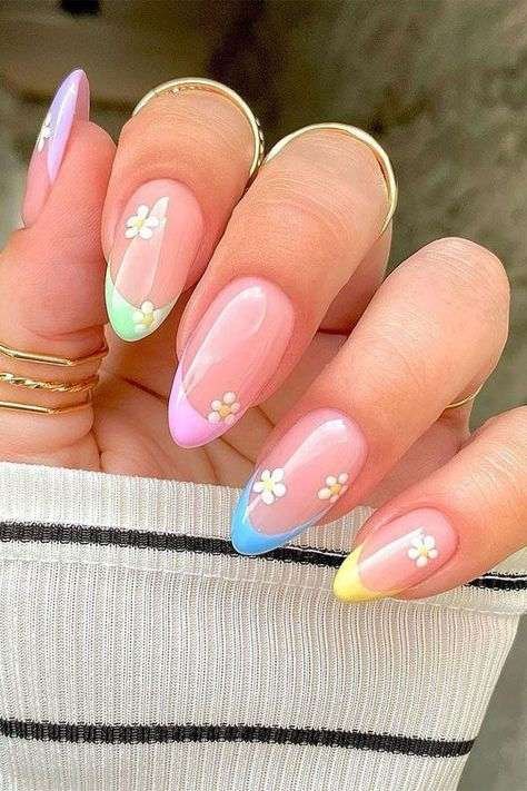 Oh, I can’t get enough of this playful manicure—you’ll love the pastel French tips in lilac, blue, and yellow! The tiny daisies add such a whimsical touch, perfect for a trendy nail art vibe that we can all adore.