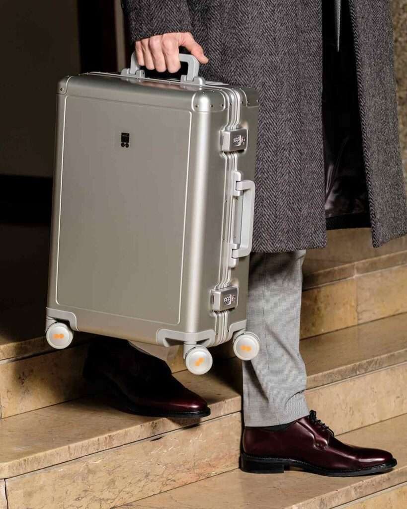 Crafted from aerospace-grade aluminum-magnesium alloy, this suitcase boasts a sleek, zipperless design with dual TSA-approved locks for enhanced security. Its ultra-quiet 360° spinner wheels and mesh interior divider ensure smooth maneuverability and organized packing.