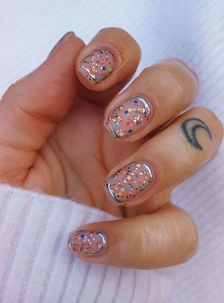 Bring the party to your fingertips. Confetti nails scatter multicolor glitter or tiny decals over a neutral or sheer base. Choi explains this look as “a fun, carefree style that instantly feels celebratory”.